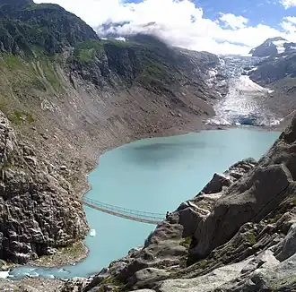 Het meer met onderaan de Triftbrücke en bovenaan de Triftgletsjer