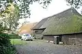 Boerderij met achterbaander en aangebouwde houten schuren