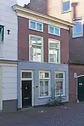Woonhuis met voorgevel uit de 19de eeuw, gebouwd in sobere classicistische vormen.