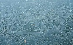 IJskristallen binnen in het natuurijs over een sloot gevormd.