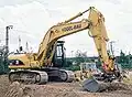 Een Caterpillar M325C graafmachine