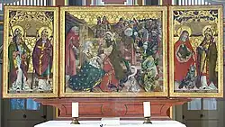 Altaardrieluik in deze kerk. Afgebeeld is o.a. de Aanbidding der Koningen en rechts St. Martinus van Tours.