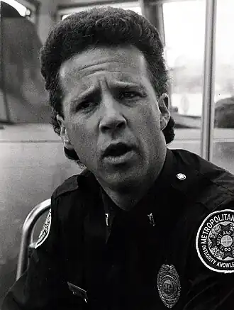 Lance Kinsey in zijn rol als Proctor in Police Academy 4  (1987)
