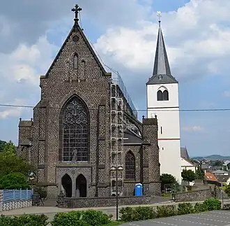 Links de neogotische kerk, rechts (met toren) de oude romaanse kerk (2014)