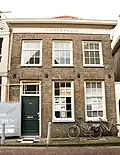 Eenvoudig woonhuis met in baksteen opgetrokken achterhuis