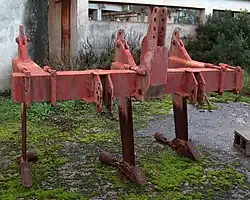 Zijaanzicht van tractor met daarachter diepwoeler in een weide