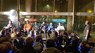 alt=Het Tech45-panel op het podium tijdens het 2e Belgische podcastfestival in Gent. Van links naar rechts:
Ruurd Sanders,
Jelle D'Hulster,
Stefaan Lesage,
Davy Buntinx,
Steven Op de beeck,
Toon van de Putte,
Maarten Hendrikx,
Floris Daelemans