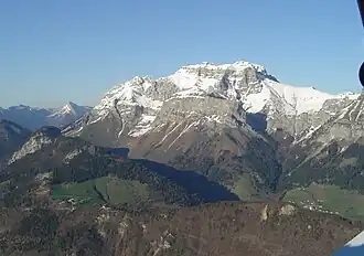 Links op de voorgrond de Col de la Forclaz. Erachter de met sneeuw bedekte La Tournette.