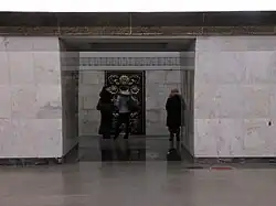 Doorkijk tussen de pylonen naar het smeedwerk op de tunnelwand