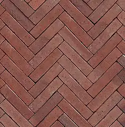 Keramische straatbaksteen in visgraatverband (Wasserstrich onbezand)