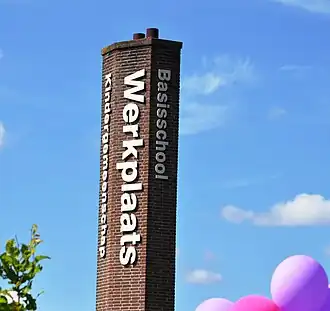 De kenmerkende zuil met de schoolnaam