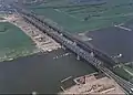1993. Gezien vanaf Zaltbommel: Rechts de Dr. W. Hupkesbrug, daarnaast de oude Bommelse brug, links is een begin gemaakt met de bouw van de Martinus Nijhoffbrug.